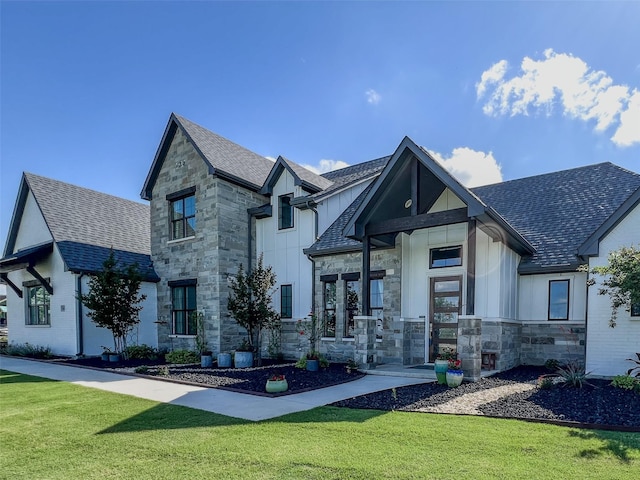 1000 Sutherland Cres, Northlake, TX 76247 - view of front of property featuring stone siding, board and batten siding, a shingled roof, and a front yard