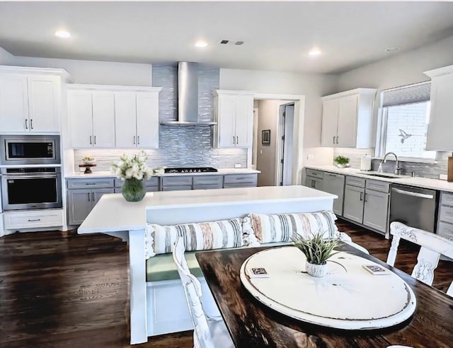 1000 Sutherland Cres, Northlake, TX 76247 - kitchen featuring stainless steel appliances, wall chimney exhaust hood, light countertops, gray cabinetry, and recessed lighting