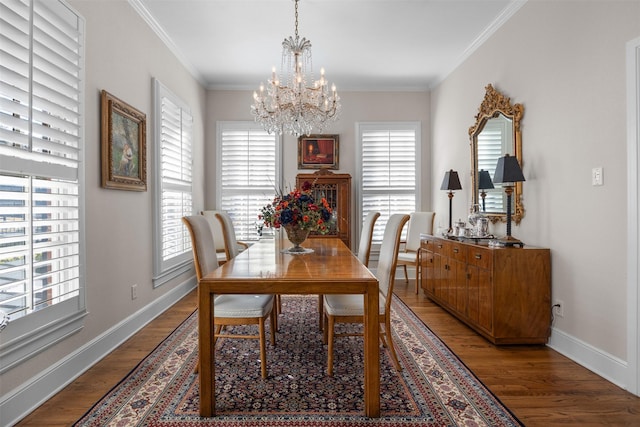 dining area featuring ornamental molding, a chandelier, baseboards, and wood finished floors