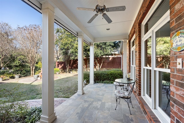 view of patio featuring ceiling fan and fence