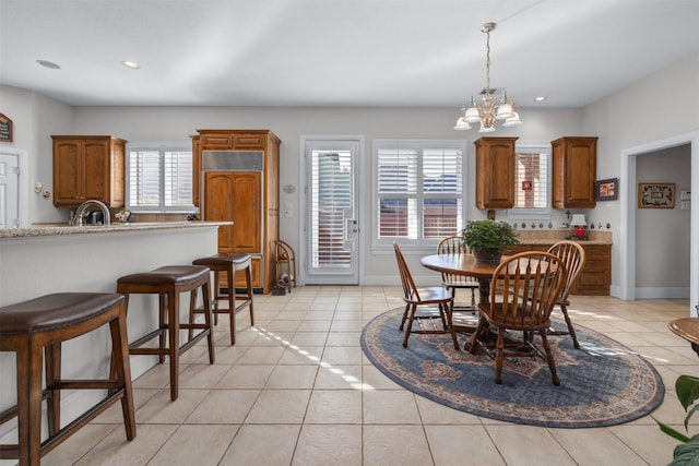 dining space with baseboards, recessed lighting, light tile patterned flooring, and an inviting chandelier