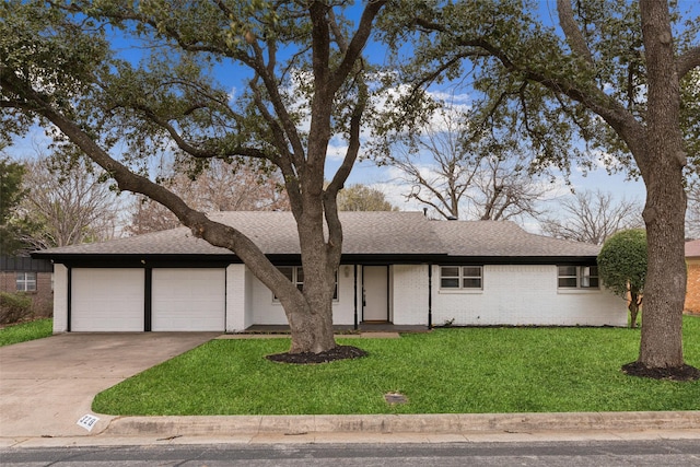 view of front of property with brick siding, a shingled roof, an attached garage, a front yard, and driveway