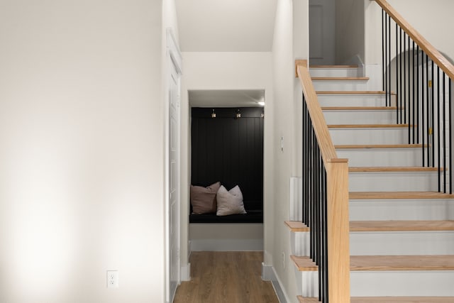 stairway with baseboards and wood finished floors