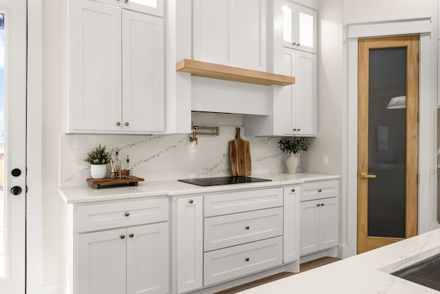 bar with decorative backsplash and black electric stovetop