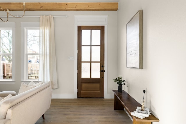 doorway to outside with wood finished floors and baseboards