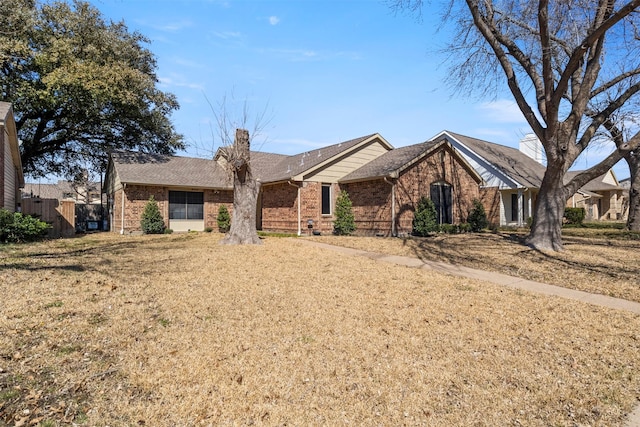 ranch-style home with brick siding and a chimney