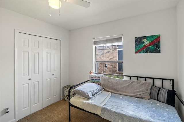 carpeted bedroom featuring a closet and a ceiling fan