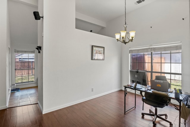 home office featuring a notable chandelier, baseboards, and wood finished floors