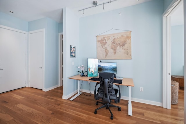 office area featuring baseboards and wood finished floors