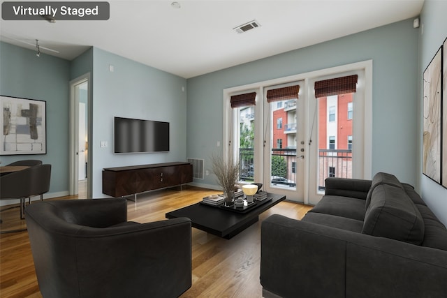 living room with visible vents and wood finished floors