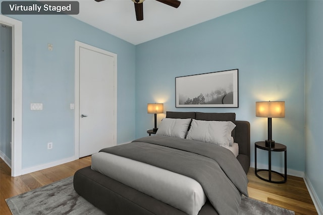 bedroom featuring a ceiling fan, wood finished floors, and baseboards