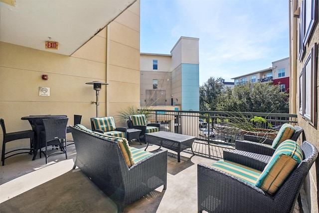 view of patio with outdoor lounge area and a balcony