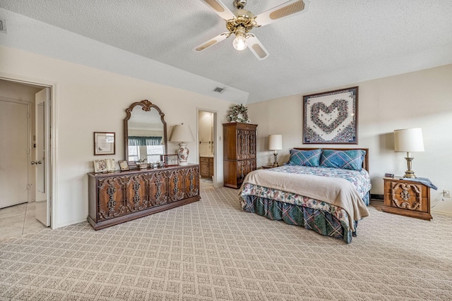 carpeted bedroom featuring a textured ceiling and visible vents