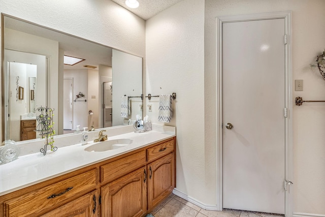 full bath with vanity and tile patterned floors