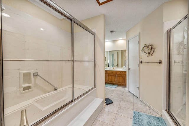 4227 Mojave Dr, Granbury, TX 76049 - bathroom featuring vanity, a textured ceiling, tile patterned floors, and bath / shower combo with glass door