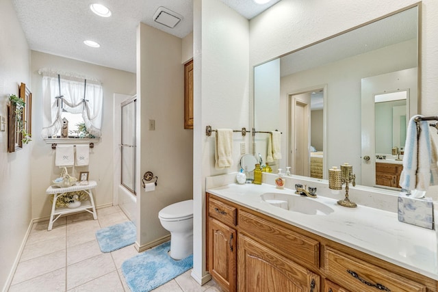 full bathroom featuring bath / shower combo with glass door, toilet, vanity, tile patterned flooring, and baseboards