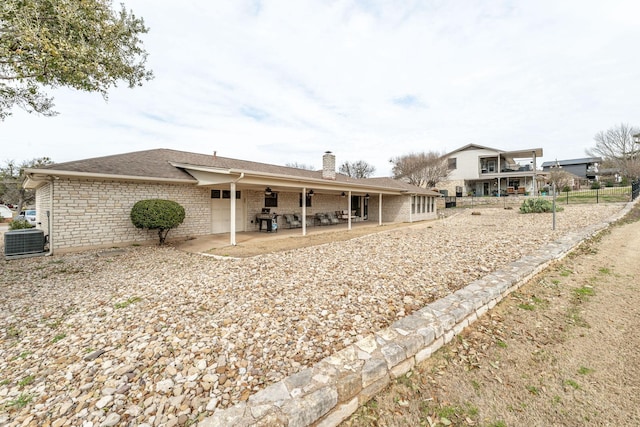 4227 Mojave Dr, Granbury, TX 76049 - back of house with central AC, a chimney, a patio, and roof with shingles