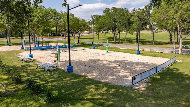 view of community with volleyball court and a yard