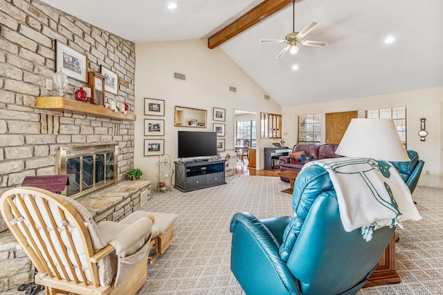 living area featuring beam ceiling, visible vents, a large fireplace, carpet flooring, and high vaulted ceiling