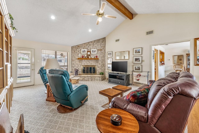 living room featuring carpet floors, beam ceiling, a fireplace, visible vents, and a ceiling fan