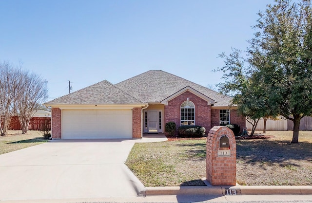 ranch-style house with concrete driveway, brick siding, fence, and an attached garage