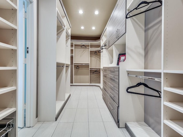 spacious closet featuring light tile patterned flooring