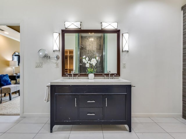 ensuite bathroom featuring tile patterned flooring, a sink, and double vanity