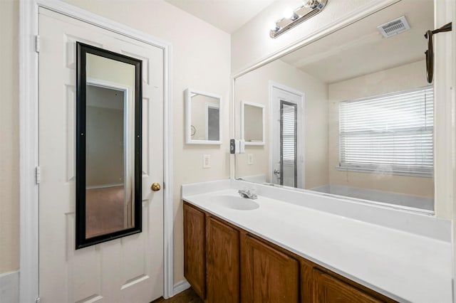 bathroom with vanity and visible vents