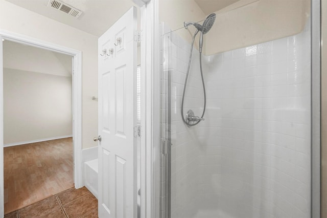 bathroom featuring a shower stall, visible vents, and tile patterned floors