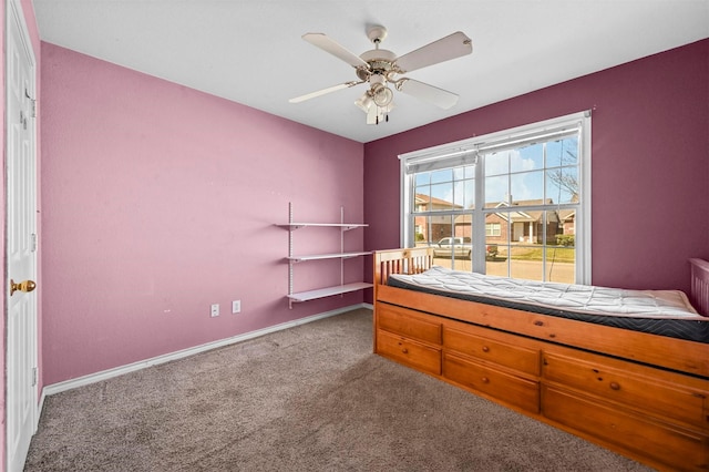 unfurnished bedroom featuring a ceiling fan, carpet flooring, and baseboards