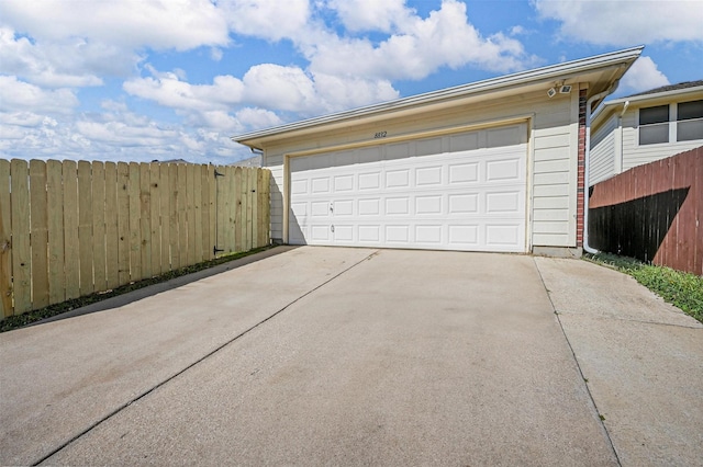 detached garage featuring fence