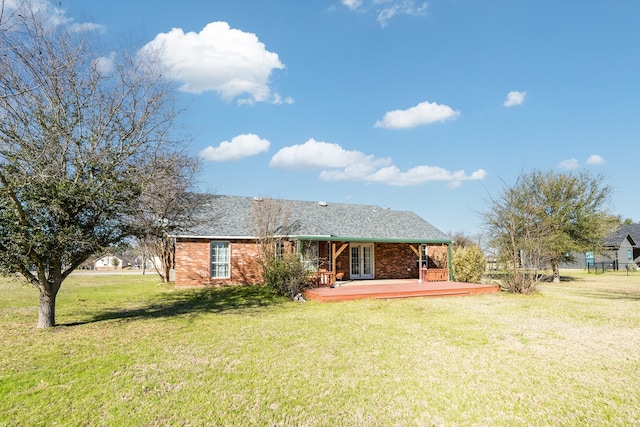 back of house with french doors, brick siding, a yard, and a wooden deck