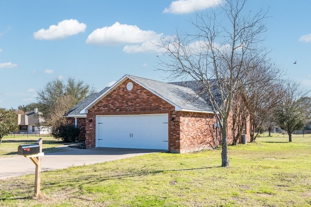 view of front facade with an attached garage, cooling unit, brick siding, concrete driveway, and a front yard