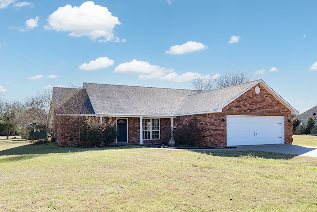 view of front facade featuring driveway, brick siding, a front lawn, and roof with shingles