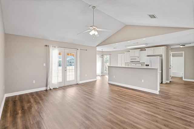 unfurnished living room with ceiling fan with notable chandelier, french doors, wood finished floors, and visible vents