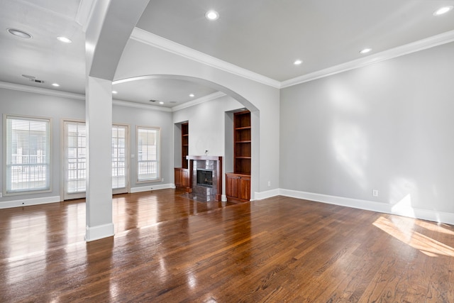 unfurnished living room with recessed lighting, dark wood finished floors, a high end fireplace, and baseboards