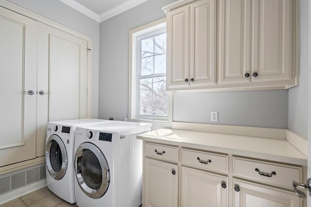 laundry area with cabinet space, visible vents, crown molding, and washing machine and clothes dryer