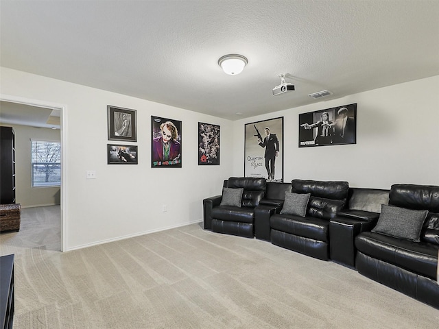 carpeted home theater featuring visible vents, baseboards, and a textured ceiling