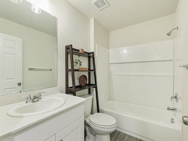 full bath with vanity, wood finished floors, visible vents, bathing tub / shower combination, and toilet