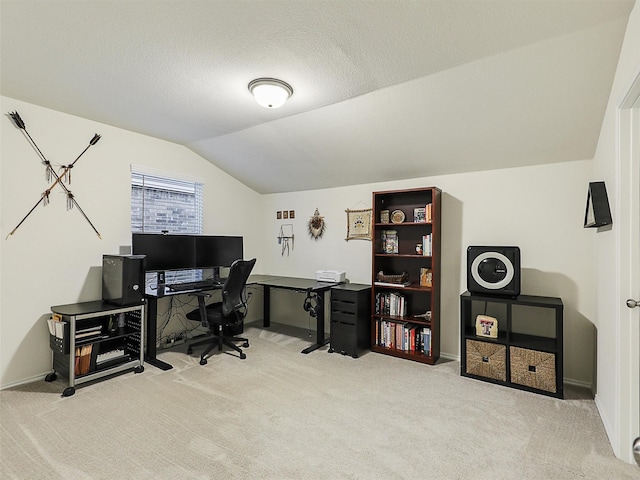 office featuring carpet flooring, a textured ceiling, baseboards, and vaulted ceiling