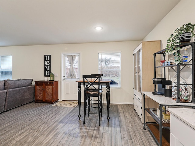 dining room with recessed lighting, baseboards, and wood finished floors