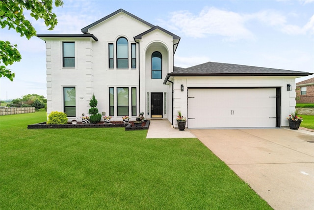 view of front of house with concrete driveway, a front lawn, roof with shingles, and an attached garage