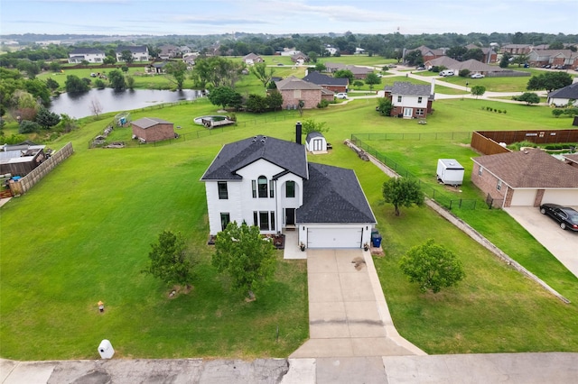 drone / aerial view with a residential view and a water view