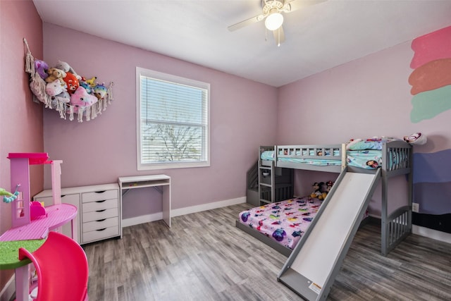 bedroom featuring a ceiling fan, baseboards, and wood finished floors