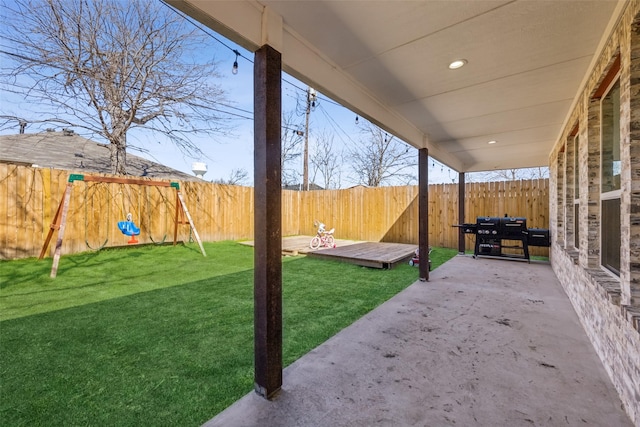 view of yard featuring a patio area, a fenced backyard, and a deck