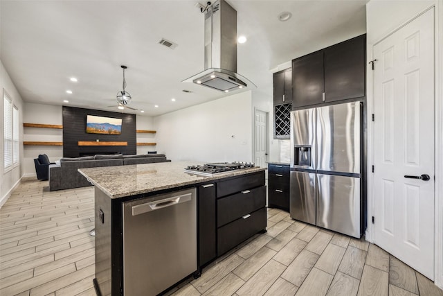 kitchen featuring stainless steel appliances, extractor fan, visible vents, and dark cabinets