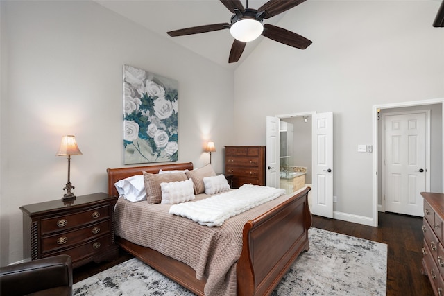 bedroom with lofted ceiling, connected bathroom, a ceiling fan, baseboards, and dark wood finished floors