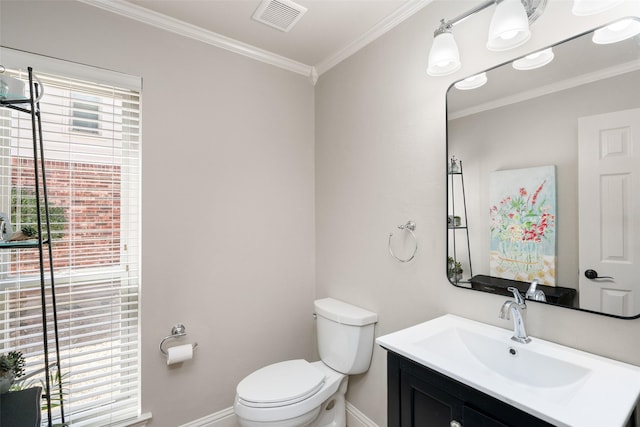 half bathroom featuring baseboards, visible vents, toilet, ornamental molding, and vanity