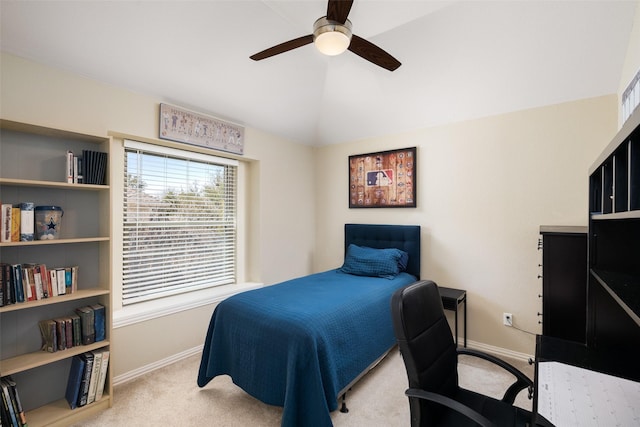 carpeted bedroom featuring vaulted ceiling, baseboards, and ceiling fan