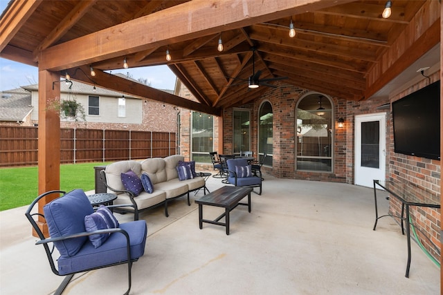 view of patio featuring an outdoor hangout area, fence, and a ceiling fan